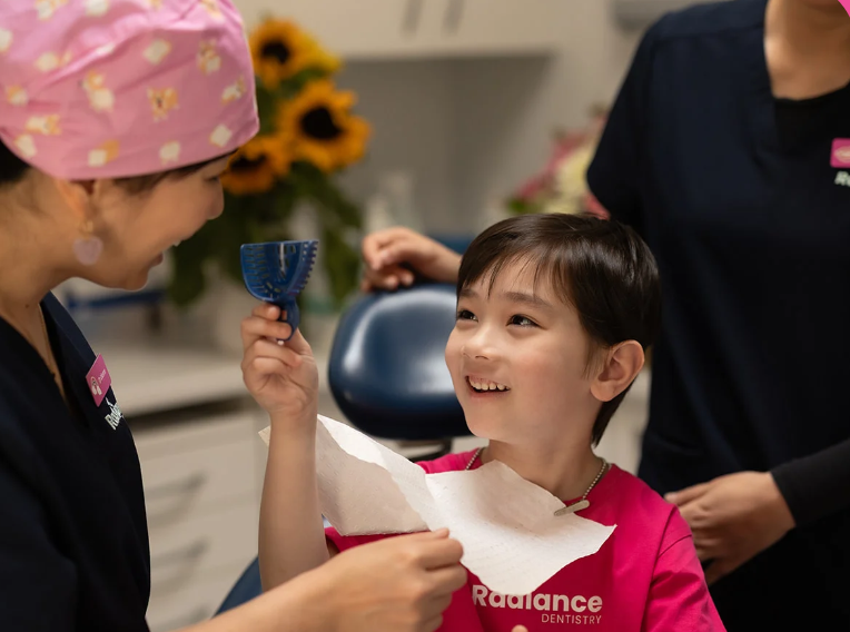 Radiance Dentistry | Dentist with young patient